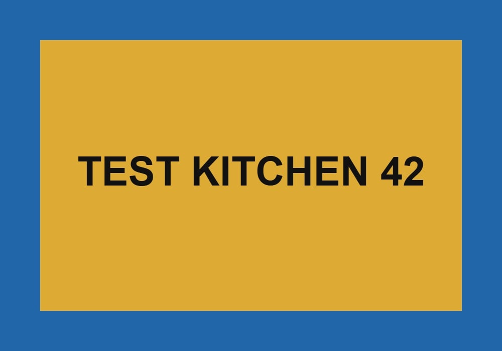 Graphic reading TEST KITCHEN 42 in black on mustard yellow and blue